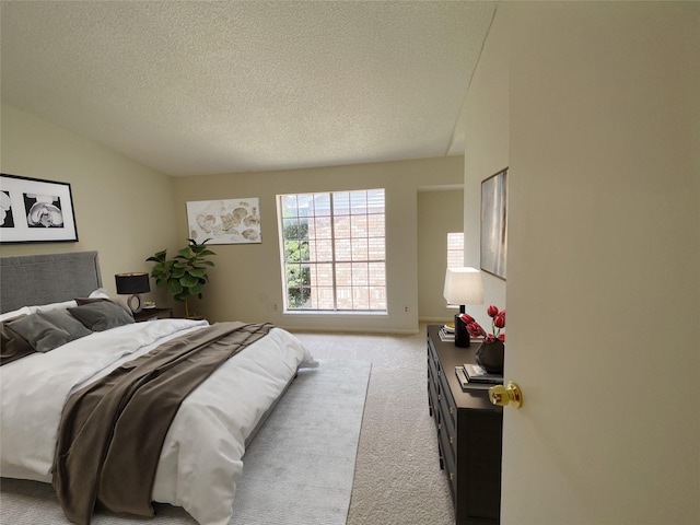 3100 Jeanetta St Unit 304, Houston, TX 77063 - carpeted bedroom featuring vaulted ceiling and a textured ceiling
