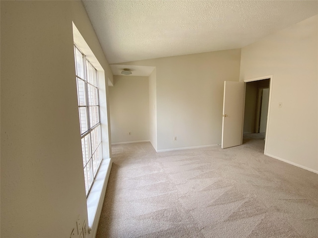 3100 Jeanetta St Unit 304, Houston, TX 77063 - empty room with lofted ceiling, a textured ceiling, and light colored carpet