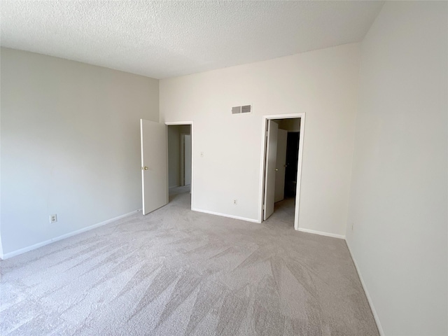 3100 Jeanetta St Unit 304, Houston, TX 77063 - unfurnished bedroom with light colored carpet and a textured ceiling