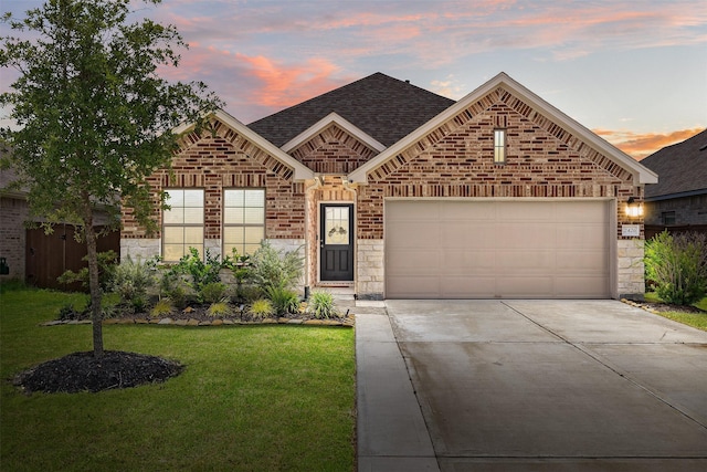 2426 Gentle Breeze Ln, Baytown, TX 77523 - view of front of property featuring concrete driveway, brick siding, a front yard, stone siding, and roof with shingles