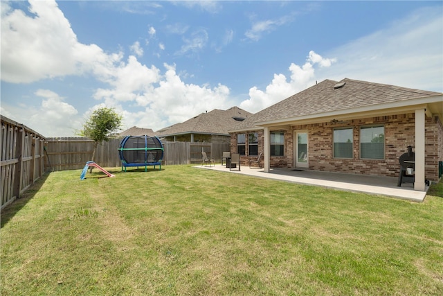 2426 Gentle Breeze Ln, Baytown, TX 77523 - fenced backyard featuring a trampoline and a patio area