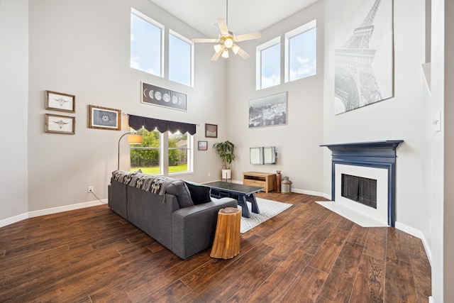 3282 Bend Cove Ct, League City, TX 77573 - living area featuring wood-type flooring, a ceiling fan, a fireplace with flush hearth, and a towering ceiling