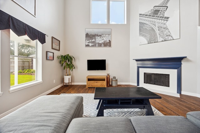3282 Bend Cove Ct, League City, TX 77573 - living room with a high ceiling, wood finished floors, and a fireplace