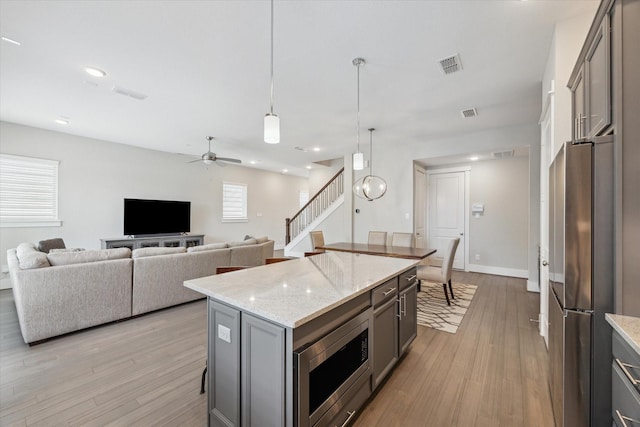 1507 Biondo Way, Houston, TX 77008 - kitchen featuring stainless steel appliances, gray cabinetry, light wood-style floors, ceiling fan, and recessed lighting