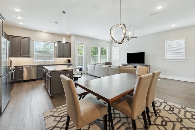 1507 Biondo Way, Houston, TX 77008 - dining room with wood-type flooring, a chandelier, and recessed lighting