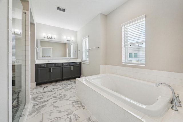 1507 Biondo Way, Houston, TX 77008 - bathroom featuring a garden tub, double vanity, and marble look tiles