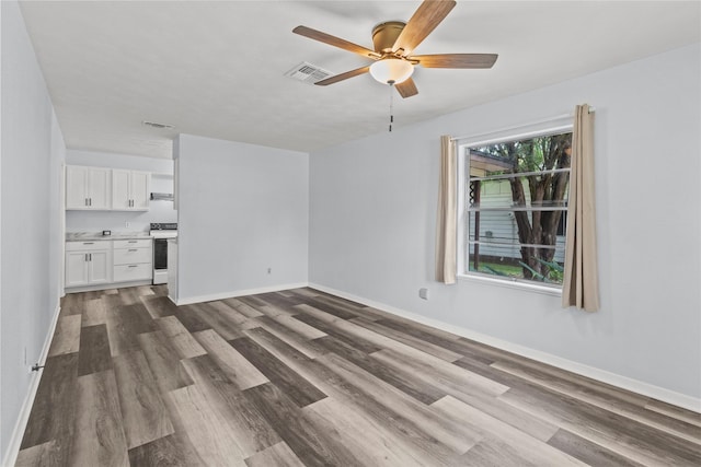 514 E Foley St, Alvin, TX 77511 - unfurnished living room with dark wood finished floors and a ceiling fan