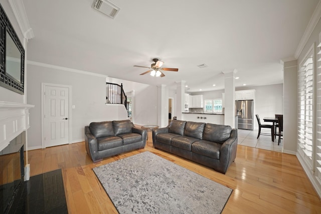 14210 Northface Manor Ct, Cypress, TX 77429 - living room featuring a ceiling fan, light wood finished floors, a fireplace, recessed lighting, and decorative columns