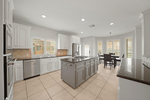 14210 Northface Manor Ct, Cypress, TX 77429 - kitchen featuring stainless steel appliances, tasteful backsplash, white cabinets, light tile patterned floors, and recessed lighting