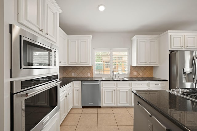 14210 Northface Manor Ct, Cypress, TX 77429 - kitchen with stainless steel appliances, white cabinets, tasteful backsplash, and recessed lighting
