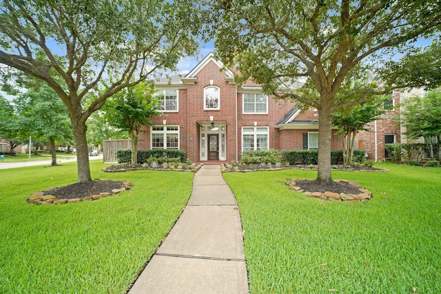 14210 Northface Manor Ct, Cypress, TX 77429 - colonial-style house with a front lawn and brick siding