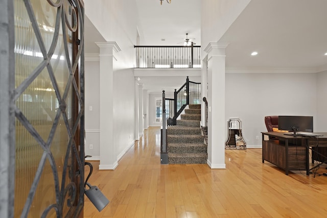 14210 Northface Manor Ct, Cypress, TX 77429 - entryway featuring decorative columns, ceiling fan, light wood-type flooring, stairway, and ornamental molding