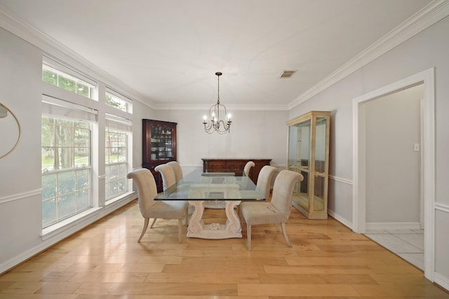 14210 Northface Manor Ct, Cypress, TX 77429 - dining area with a chandelier, light wood-style flooring, and crown molding