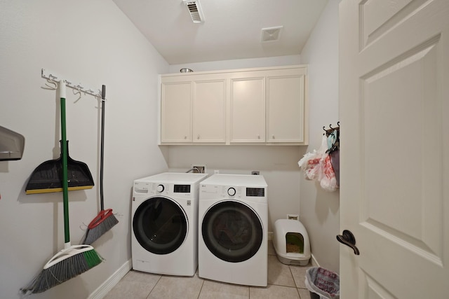 14210 Northface Manor Ct, Cypress, TX 77429 - laundry area with washing machine and dryer, cabinet space, and light tile patterned flooring