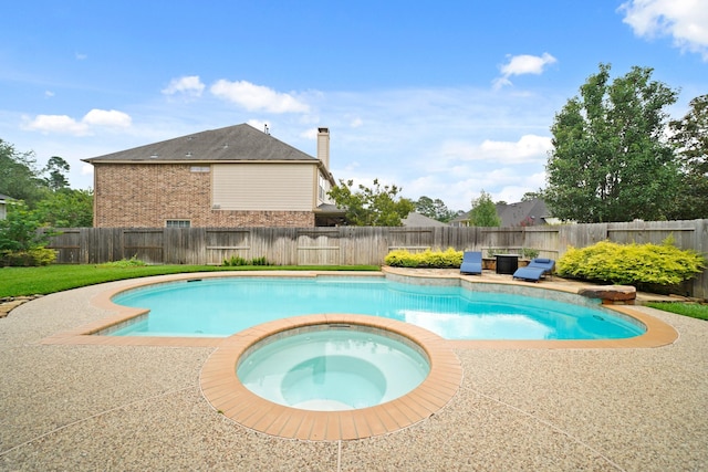 14210 Northface Manor Ct, Cypress, TX 77429 - view of swimming pool with a patio, a fenced backyard, and a pool with connected hot tub