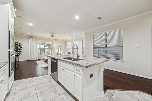 831 W 26th St, Houston, TX 77008 - kitchen featuring crown molding, appliances with stainless steel finishes, a center island with sink, light stone counters, and recessed lighting
