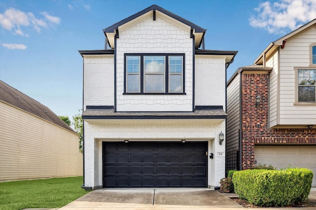 831 W 26th St, Houston, TX 77008 - view of front facade featuring a garage, concrete driveway, and brick siding