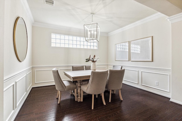 831 W 26th St, Houston, TX 77008 - dining room with a chandelier, crown molding, a decorative wall, dark wood-style flooring, and wainscoting