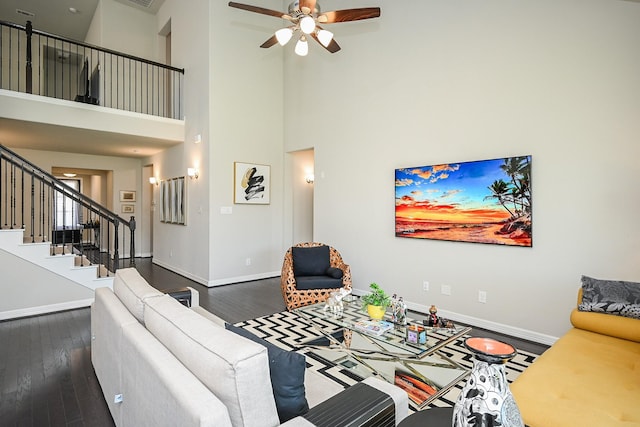 24311 Orley Island Ct, Katy, TX 77493 - living area with dark wood-type flooring, a ceiling fan, stairway, and a towering ceiling