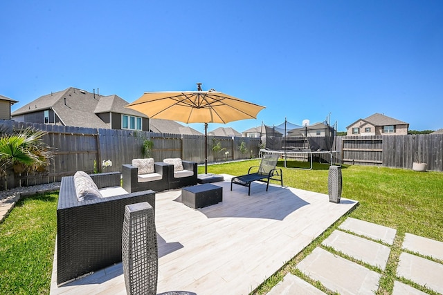 24311 Orley Island Ct, Katy, TX 77493 - fenced backyard with a trampoline, a residential view, and a wooden deck