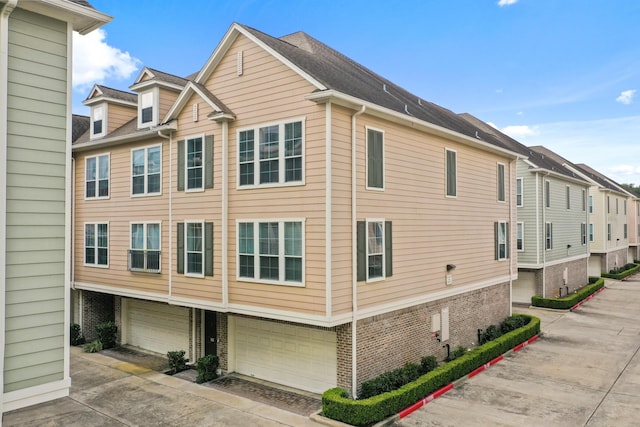 3001 Murworth Dr Unit 1606, Houston, TX 77025 - view of side of property featuring brick siding, concrete driveway, and a garage