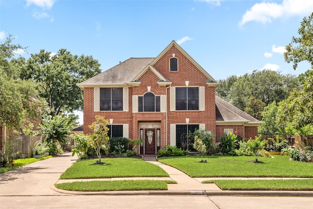 7943 Scenic Canyon Ln, Houston, TX 77095 - view of front of house with brick siding, roof with shingles, and concrete driveway