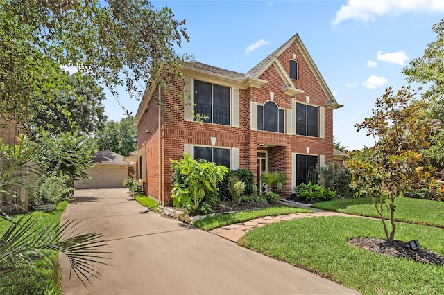 7943 Scenic Canyon Ln, Houston, TX 77095 - view of front of home with brick siding, a front yard, and a garage