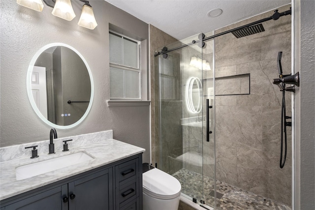 7943 Scenic Canyon Ln, Houston, TX 77095 - full bathroom with vanity, a stall shower, a textured wall, and a textured ceiling