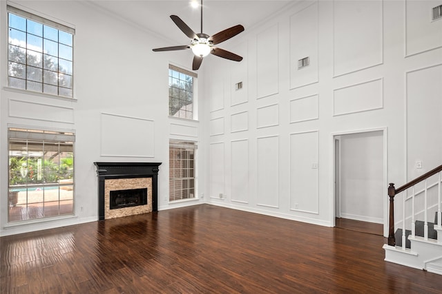 7943 Scenic Canyon Ln, Houston, TX 77095 - unfurnished living room with a towering ceiling, a ceiling fan, a fireplace, stairs, and healthy amount of natural light