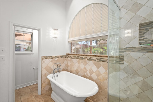 7943 Scenic Canyon Ln, Houston, TX 77095 - full bath featuring a freestanding tub, plenty of natural light, tile walls, and tile patterned flooring