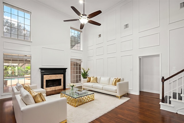 7943 Scenic Canyon Ln, Houston, TX 77095 - living area featuring a towering ceiling, dark wood-type flooring, plenty of natural light, a ceiling fan, and stairway