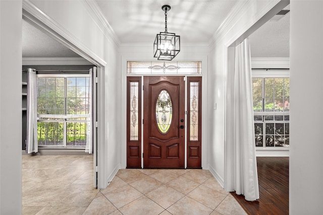 7943 Scenic Canyon Ln, Houston, TX 77095 - foyer entrance featuring a chandelier, healthy amount of natural light, light tile patterned floors, and ornamental molding
