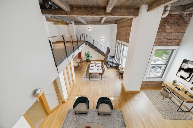 915 Franklin St Unit 9L, Houston, TX 77002 - stairs with wood finished floors, beam ceiling, and a towering ceiling