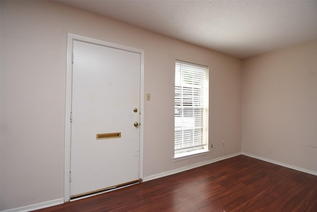 9007 Gaylord St Unit 23, Houston, TX 77024 - foyer with wood finished floors and a textured ceiling