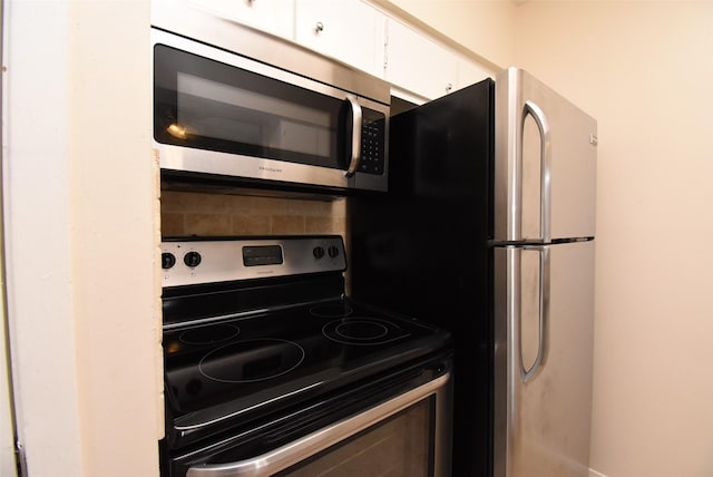 9007 Gaylord St Unit 23, Houston, TX 77024 - kitchen with appliances with stainless steel finishes and white cabinets