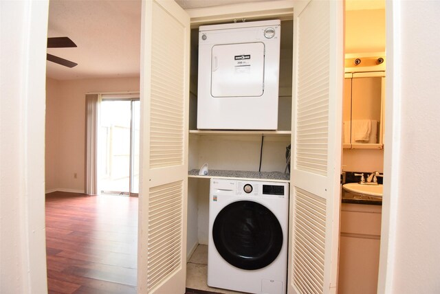 9007 Gaylord St Unit 23, Houston, TX 77024 - laundry room with estacked washer and dryer, wood finished floors, and ceiling fan
