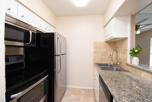 9007 Gaylord St Unit 23, Houston, TX 77024 - kitchen featuring appliances with stainless steel finishes, backsplash, white cabinets, a ceiling fan, and light stone counters