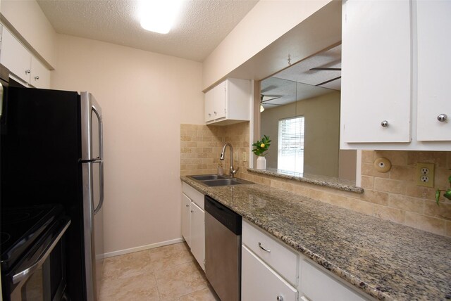 9007 Gaylord St Unit 23, Houston, TX 77024 - kitchen featuring appliances with stainless steel finishes, backsplash, white cabinets, ceiling fan, and light stone countertops