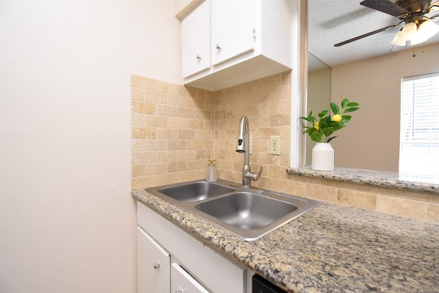 9007 Gaylord St Unit 23, Houston, TX 77024 - kitchen featuring tasteful backsplash, white cabinets, light countertops, a ceiling fan, and a textured ceiling