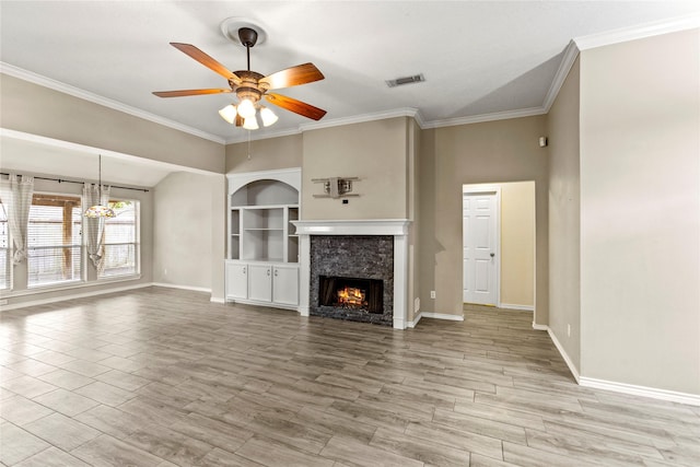 110 Rustling Wind Dr, Montgomery, TX 77356 - unfurnished living room featuring a ceiling fan, a tile fireplace, ornamental molding, wood finished floors, and a chandelier