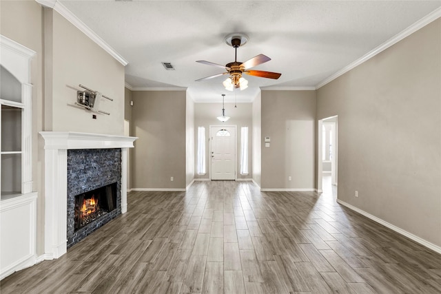 110 Rustling Wind Dr, Montgomery, TX 77356 - unfurnished living room featuring a ceiling fan, a warm lit fireplace, wood finished floors, and ornamental molding