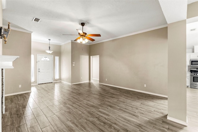 110 Rustling Wind Dr, Montgomery, TX 77356 - unfurnished living room featuring ceiling fan, wood finished floors, and ornamental molding