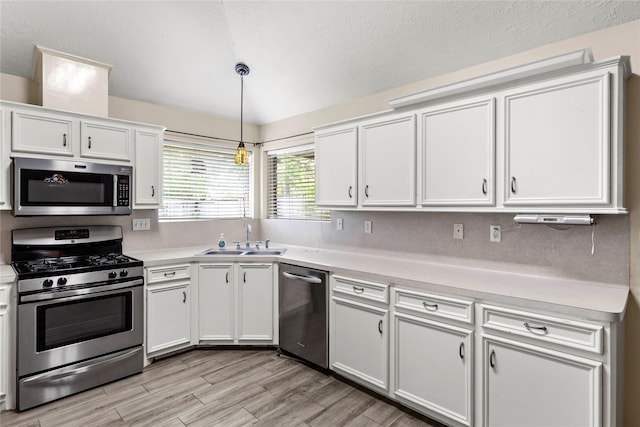 110 Rustling Wind Dr, Montgomery, TX 77356 - kitchen with appliances with stainless steel finishes, light countertops, white cabinets, and light wood-style flooring