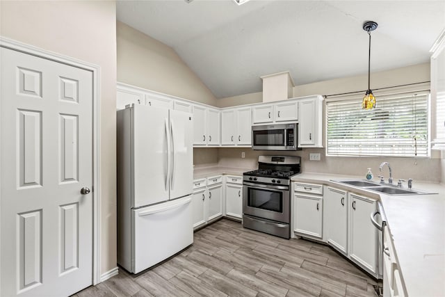 110 Rustling Wind Dr, Montgomery, TX 77356 - kitchen with stainless steel appliances, light countertops, lofted ceiling, and white cabinetry