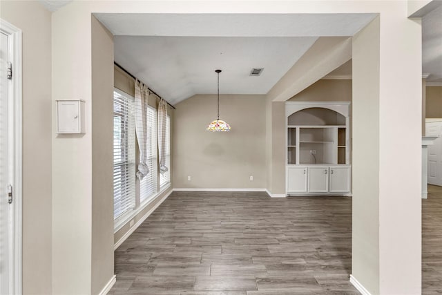 110 Rustling Wind Dr, Montgomery, TX 77356 - unfurnished dining area with wood finished floors and vaulted ceiling