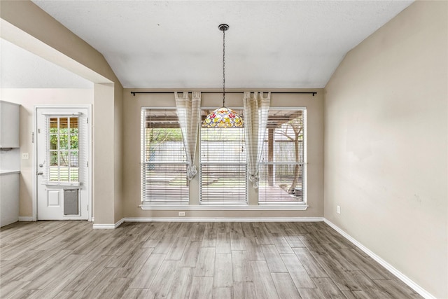 110 Rustling Wind Dr, Montgomery, TX 77356 - unfurnished dining area with lofted ceiling and wood finished floors