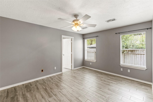 110 Rustling Wind Dr, Montgomery, TX 77356 - empty room with a textured ceiling, wood finished floors, and ceiling fan