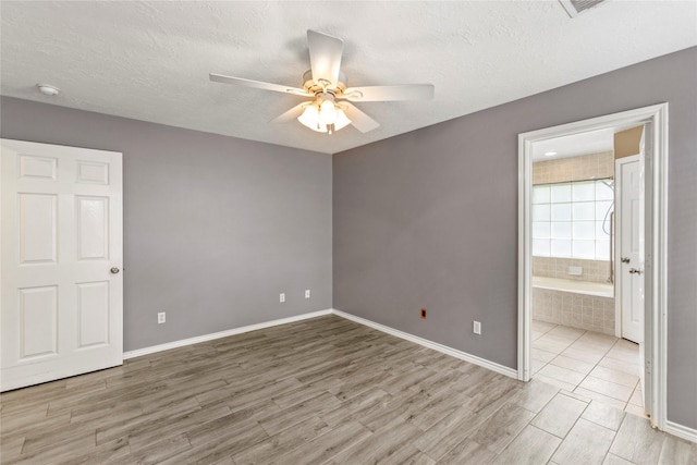 110 Rustling Wind Dr, Montgomery, TX 77356 - unfurnished bedroom with wood finished floors, a textured ceiling, ensuite bath, and a ceiling fan