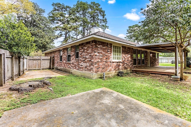 110 Rustling Wind Dr, Montgomery, TX 77356 - view of side of home featuring a patio, a chimney, a fenced backyard, brick siding, and a wooden deck