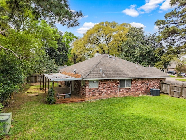 110 Rustling Wind Dr, Montgomery, TX 77356 - rear view of property with a fenced backyard, a wooden deck, brick siding, and roof with shingles